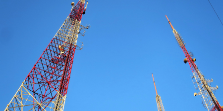 Telecommunication Towers/Masts rising high to the blue and clear sky.