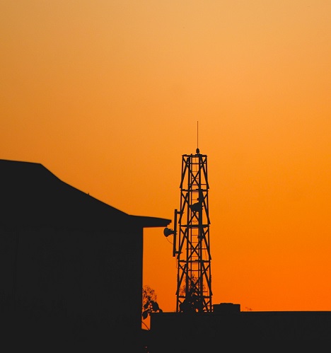 House and a Telecommunications Tower sunset silhouette